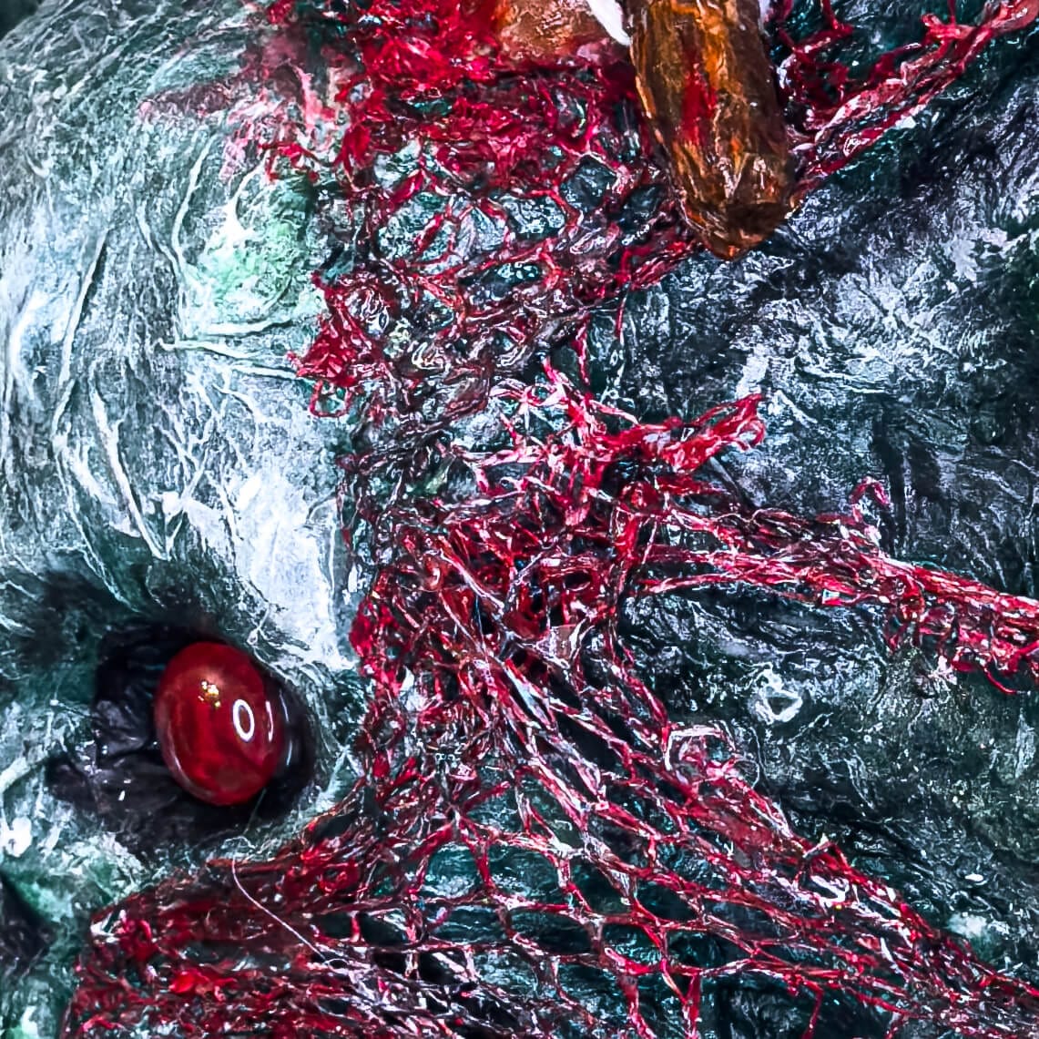 Close up of 3D mixed media acrylic skull & stake artwork